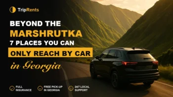 Black SUV driving a scenic mountain road in Georgia