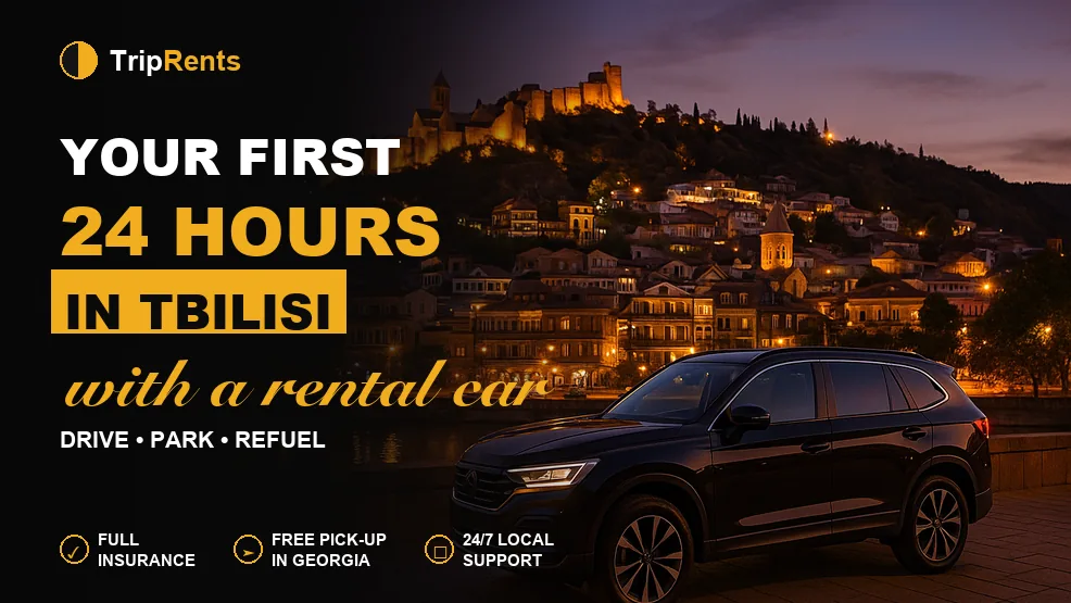Black SUV parked on a Tbilisi embankment at dusk with Narikala fortress in the background